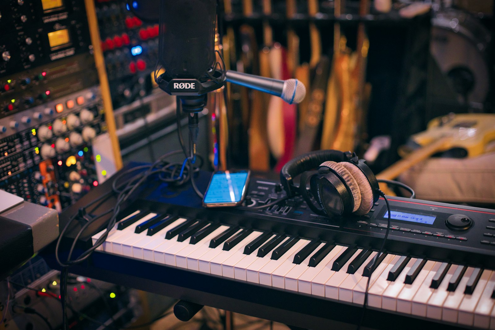 A single microphone in moody half-light — the visual register of a stripped-back trio concert